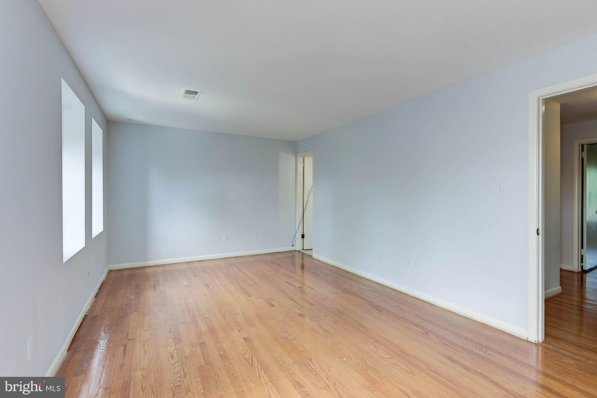 2148 Military Road Arlington, VA 22207 - Photo 5 of 28 an empty room with wooden floor and windows