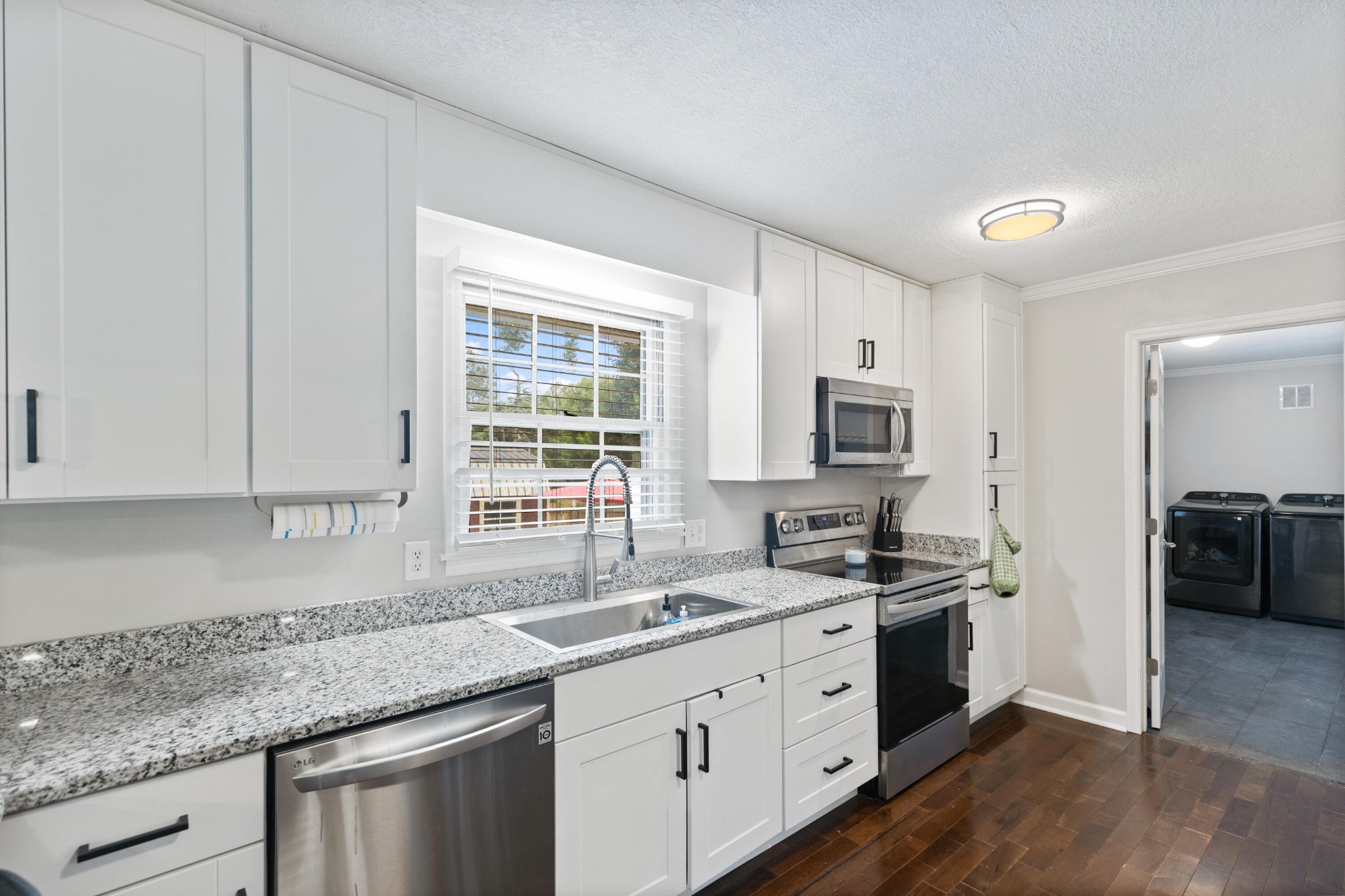 2000 Georgetown Road Northwest Cleveland, TN 37311 - Photo 11 of 36 a kitchen with stainless steel appliances granite countertop a sink stove and cabinets