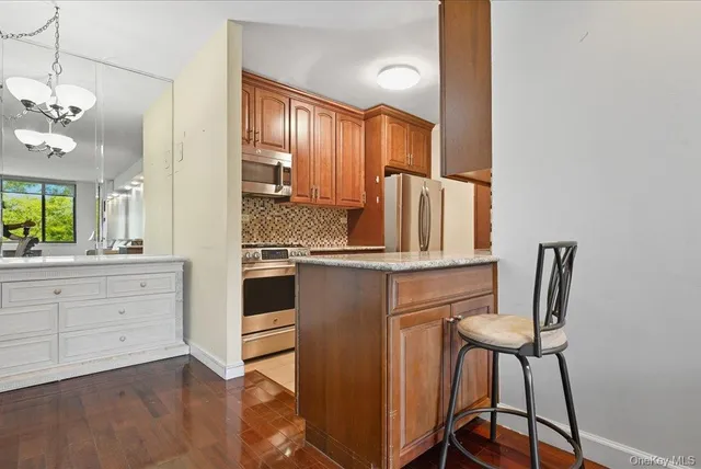 a kitchen with a table chairs refrigerator and cabinets