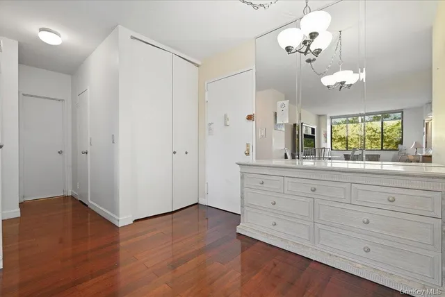 a spacious bathroom with a granite countertop sink a mirror and a shower
