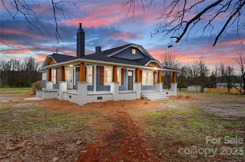3711 Sikes Mill Road Monroe, NC 28110 - Photo 1 of 46 a front view of a house with a yard