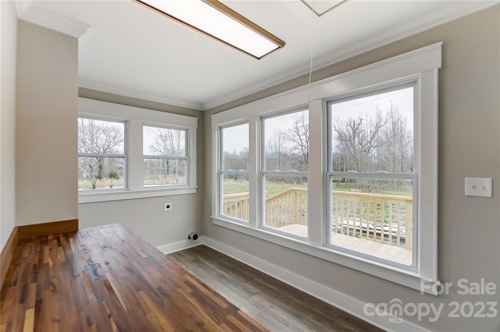3711 Sikes Mill Road Monroe, NC 28110 - Photo 25 of 46 a view of an empty room with a window and wooden floor