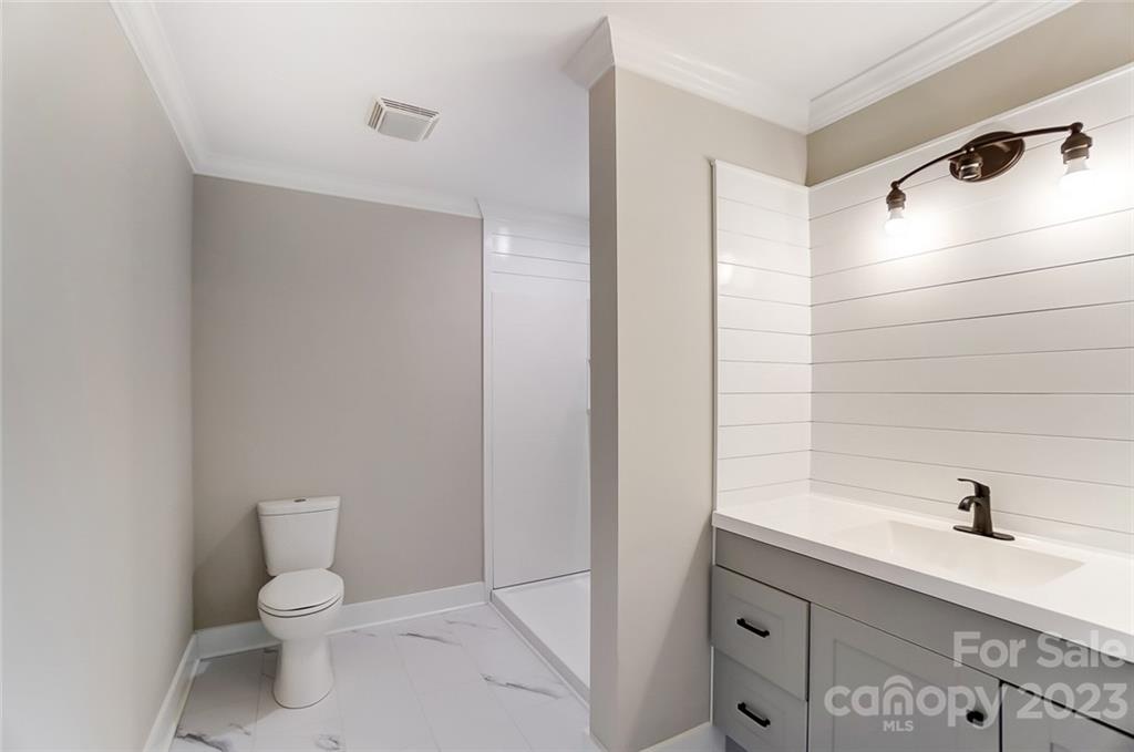 3711 Sikes Mill Road Monroe, NC 28110 - Photo 30 of 46 a bathroom with a sink a toilet and shower