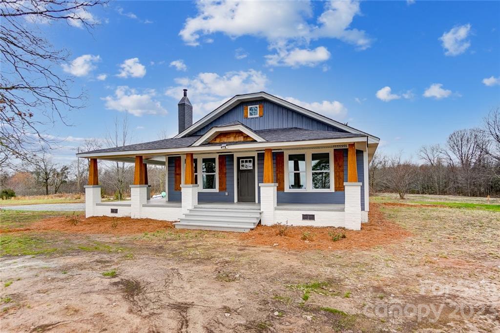 3711 Sikes Mill Road Monroe, NC 28110 - Photo 6 of 46 a front view of a house with a yard