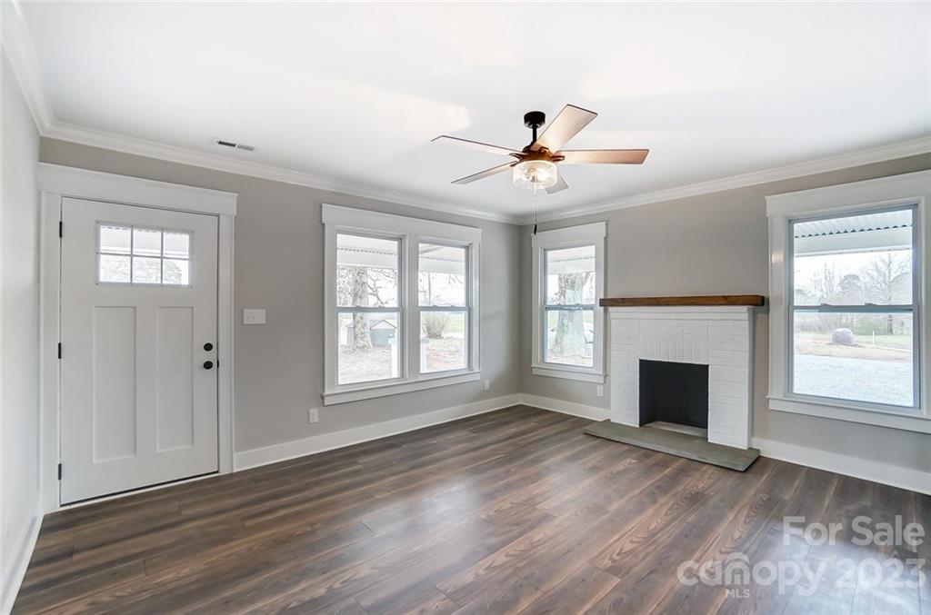 3711 Sikes Mill Road Monroe, NC 28110 - Photo 9 of 46 a view of an empty room with a window and fireplace