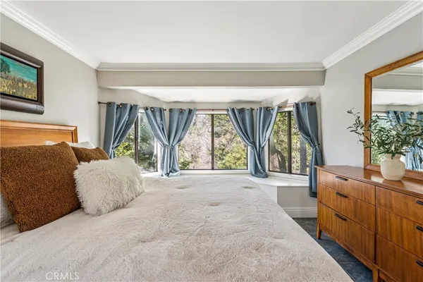 a bedroom with furniture and a large window