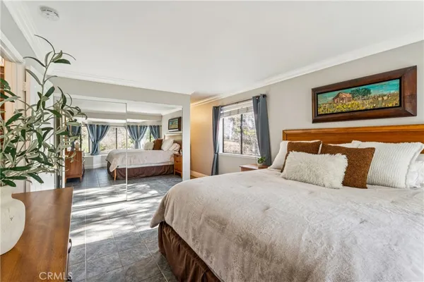a spacious bedroom with a bed and a couch
