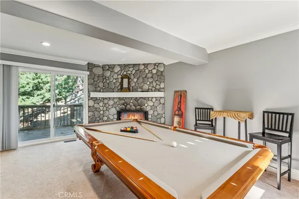 a room with a fireplace and a large window