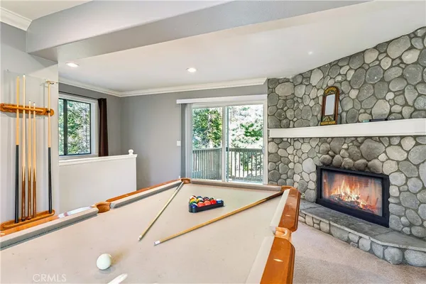 a room with pool table and windows