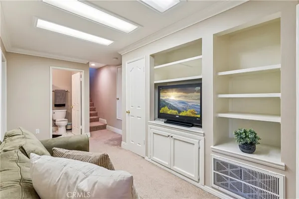 a large bed sitting in a bedroom next to a window