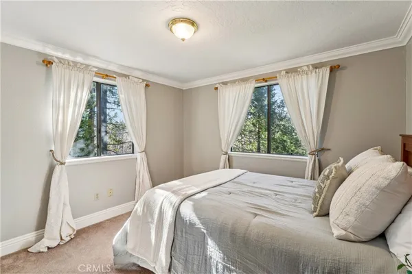 a bedroom with a bed and large mirror