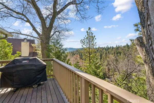 a view of balcony with wooden floor and fence