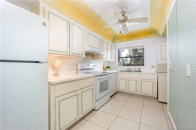 a kitchen with cabinets and window