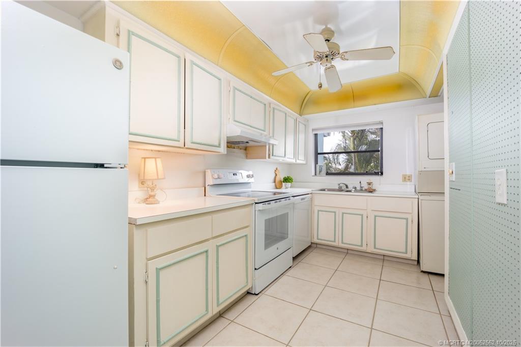 3901 Southeast St Lucie Boulevard, Unit B14 Stuart, FL 34997 - Photo 13 of 37 a kitchen with cabinets and window