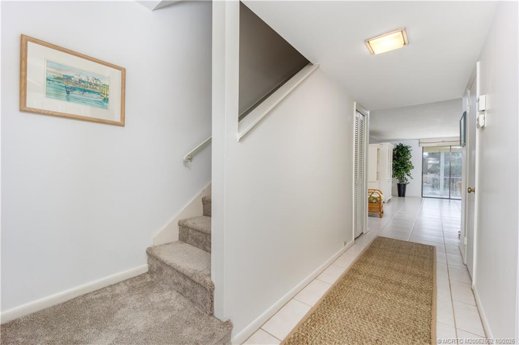 3901 Southeast St Lucie Boulevard, Unit B14 Stuart, FL 34997 - Photo 14 of 37 a view of a hallway with wooden floor and entryway