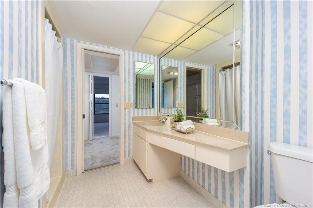 3901 Southeast St Lucie Boulevard, Unit B14 Stuart, FL 34997 - Photo 16 of 37 a bathroom with a double vanity sink and a mirror