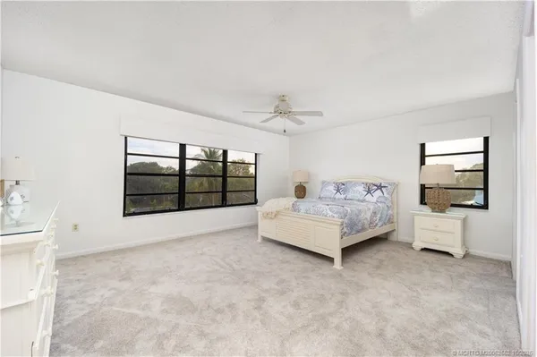 a spacious bedroom with a bed and a large window