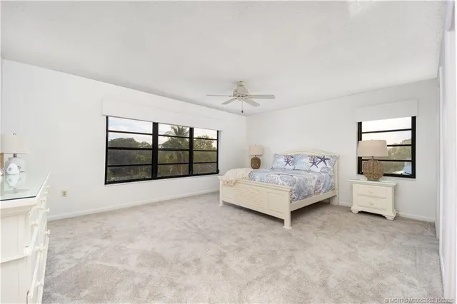 a spacious bedroom with a bed and a large window