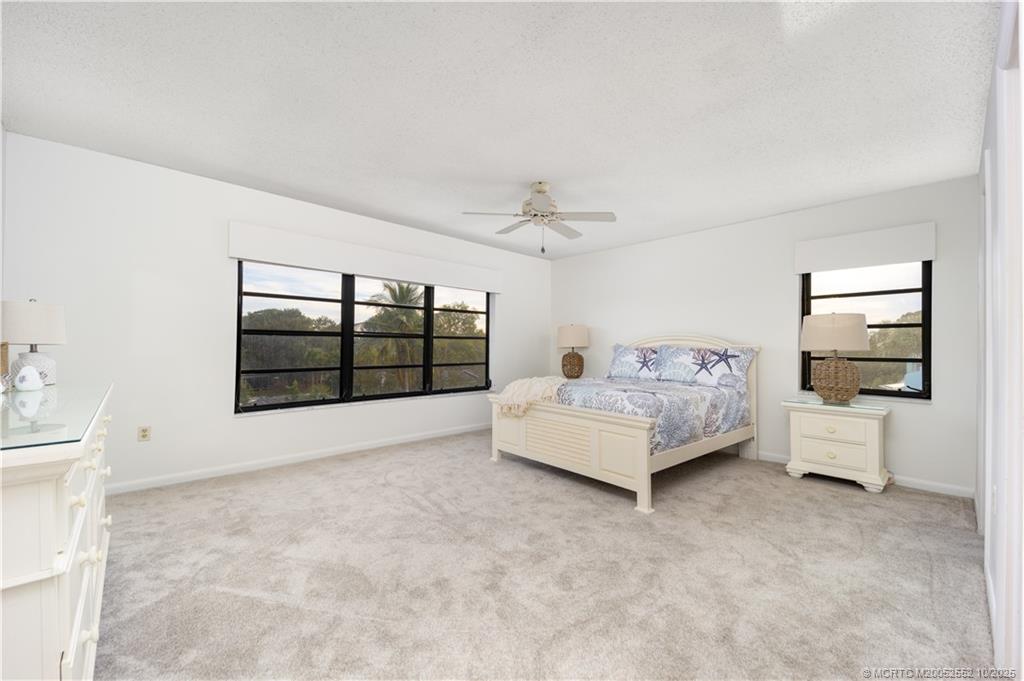 3901 Southeast St Lucie Boulevard, Unit B14 Stuart, FL 34997 - Photo 17 of 37 a spacious bedroom with a bed and a large window