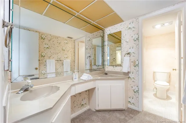 a bathroom with a double vanity sink mirror and double
