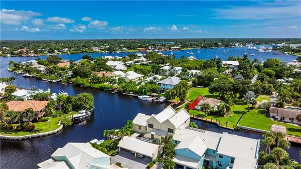 an aerial view of a houses with yard