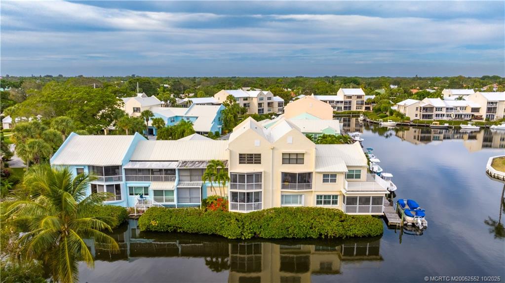 3901 Southeast St Lucie Boulevard, Unit B14 Stuart, FL 34997 - Photo 3 of 37 a front view of a house with a garden and lake view