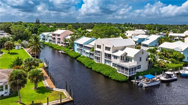 a aerial view of a house with outdoor space and lake view