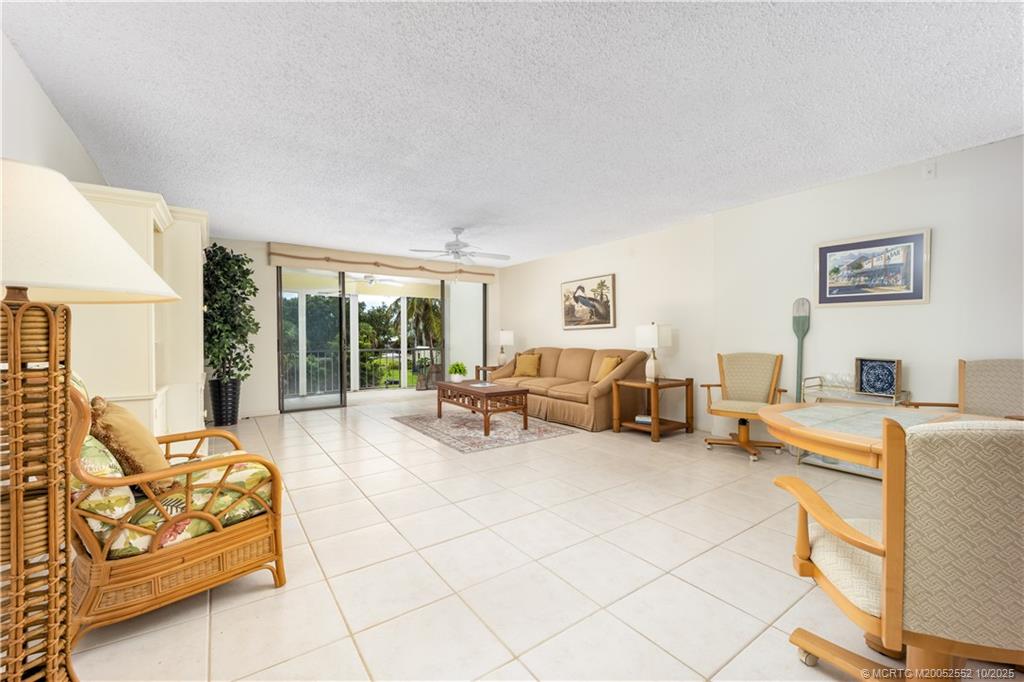 3901 Southeast St Lucie Boulevard, Unit B14 Stuart, FL 34997 - Photo 8 of 37 a living room with furniture and a table