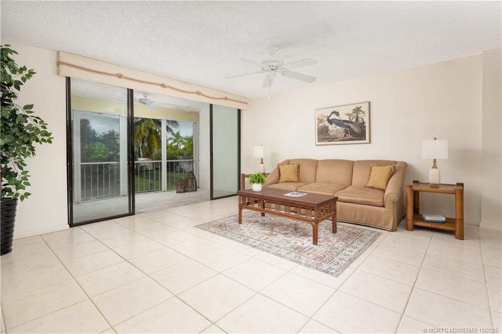 3901 Southeast St Lucie Boulevard, Unit B14 Stuart, FL 34997 - Photo 9 of 37 a living room with furniture and a gate