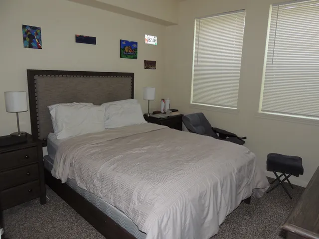 a bedroom with bed and window