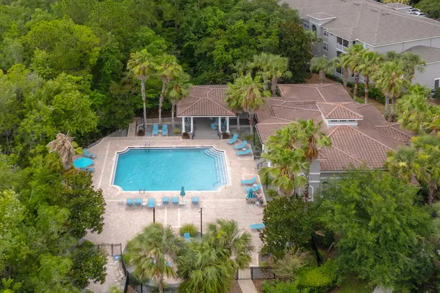 an aerial view of a house with garden space and sitting area