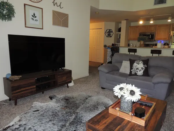 a living room with furniture and a flat screen tv