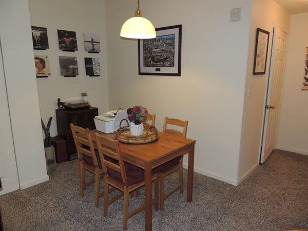 a view of a dining room with furniture and a window