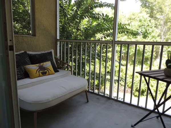 a balcony with furniture and garden view