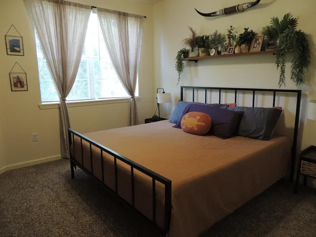 a bedroom with a bed and a window