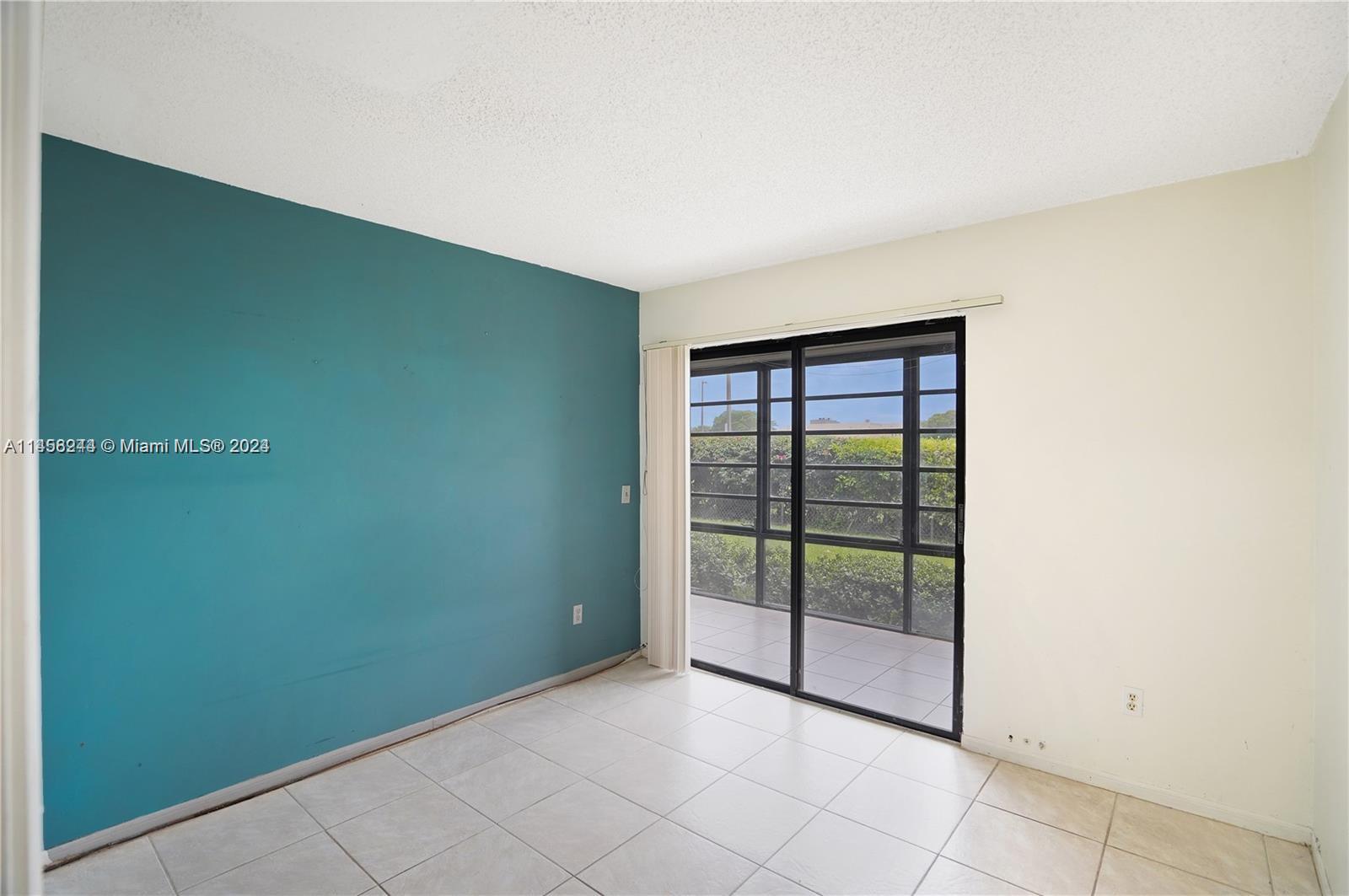 9727 Hammocks Boulevard, Unit 103D Miami, FL 33196 - Photo 2 of 11 a view of a room with sliding door and mountain view