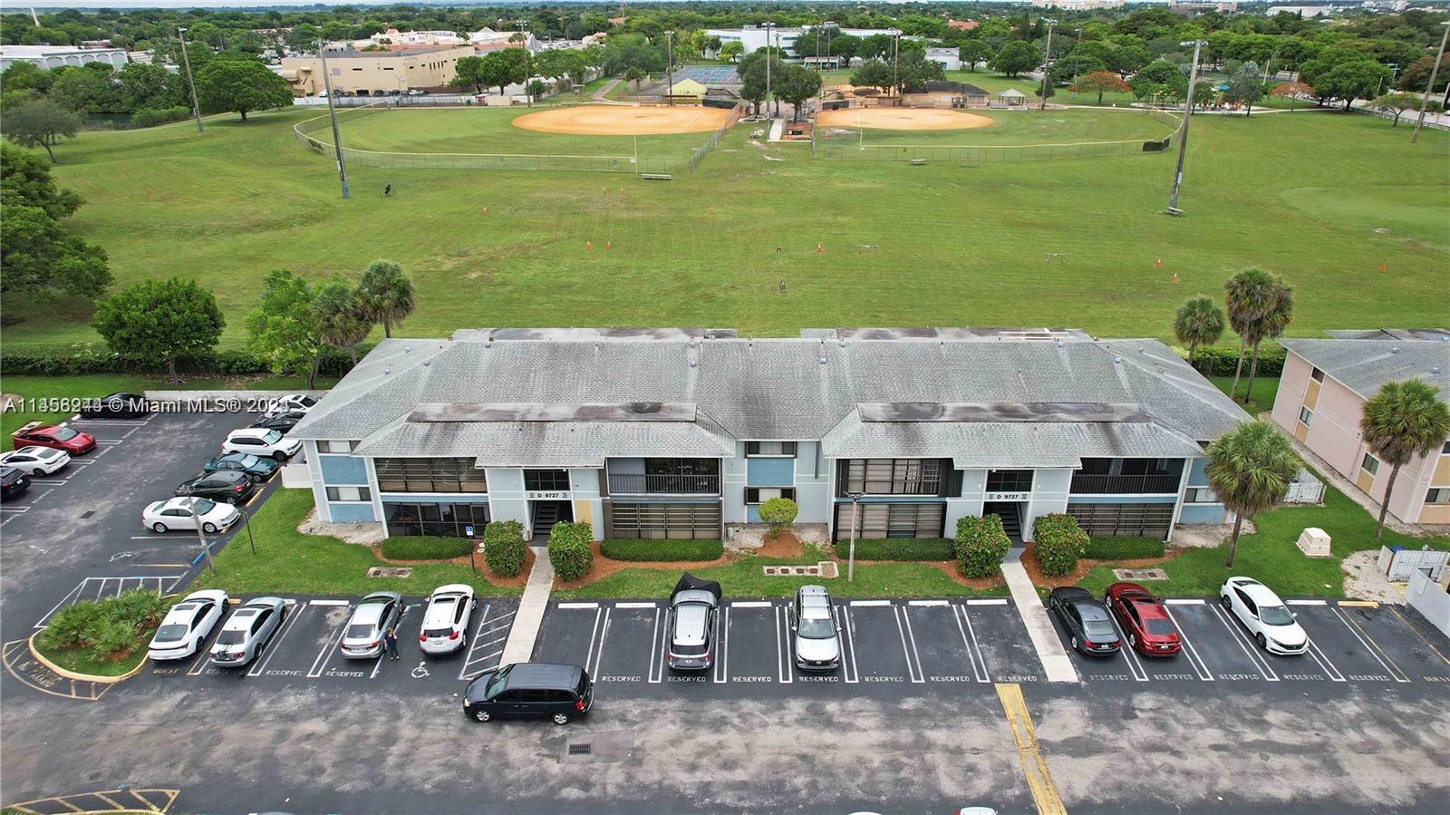 9727 Hammocks Boulevard, Unit 103D Miami, FL 33196 - Photo 3 of 11 an aerial view of a house with garden space and street view