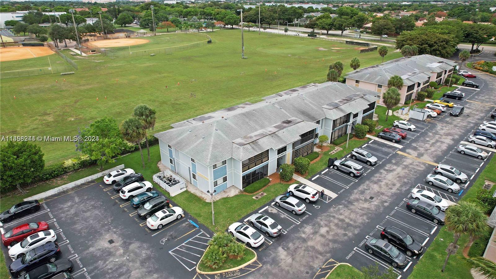 9727 Hammocks Boulevard, Unit 103D Miami, FL 33196 - Photo 4 of 11 an aerial view of a house with a garden and lake view
