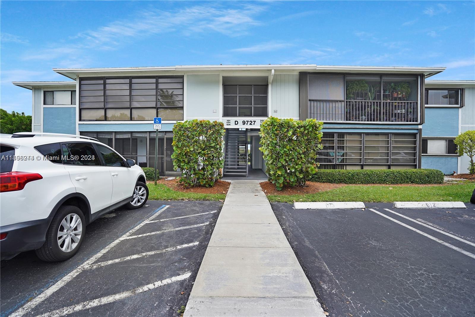 9727 Hammocks Boulevard, Unit 103D Miami, FL 33196 - Photo 5 of 11 a view of a car parked in front of a house