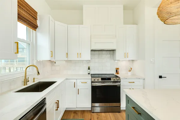 a kitchen with a sink stove and cabinets