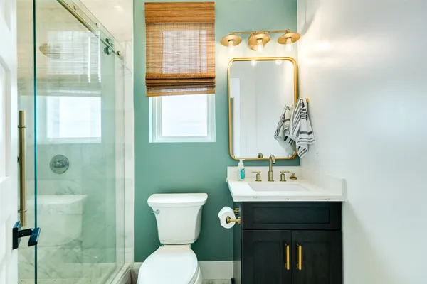 a bathroom with a toilet sink and mirror