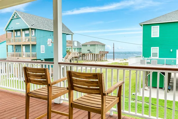 a view of a chairs and table in the balcony