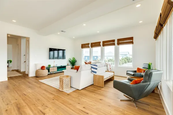 a living room with furniture and floor to ceiling window