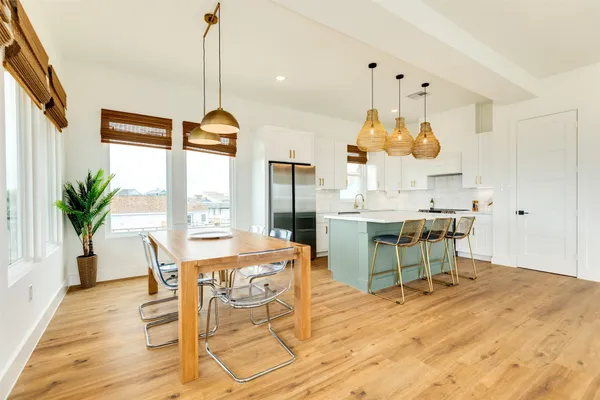 a dining room filled with furniture and wooden floor