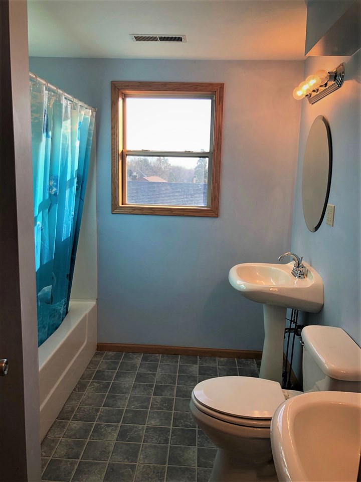 1904 Ridgeland Road Rockford, IL 61108 - Photo 12 of 20 a bathroom with a toilet sink and mirror