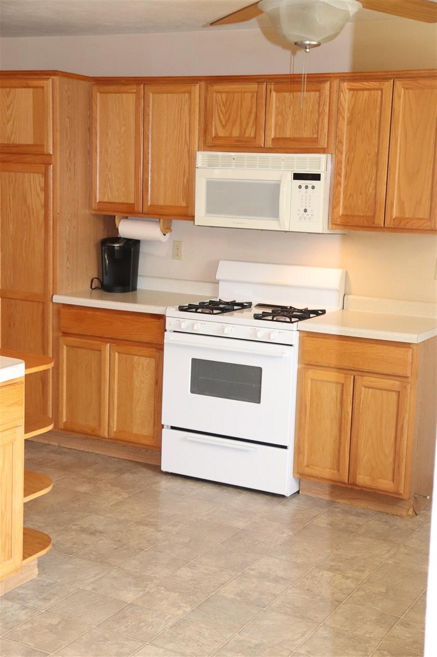1904 Ridgeland Road Rockford, IL 61108 - Photo 5 of 20 a kitchen with granite countertop white cabinets stainless steel appliances and a sink