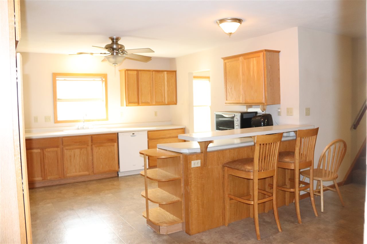 1904 Ridgeland Road Rockford, IL 61108 - Photo 6 of 20 a dining room with furniture a window and wooden floor