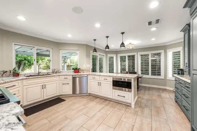 a large white kitchen with a large window