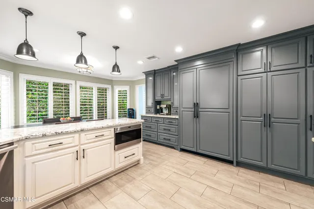 a kitchen with appliances cabinets and a sink