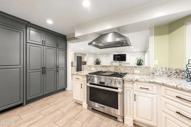 a kitchen with a stove and a refrigerator